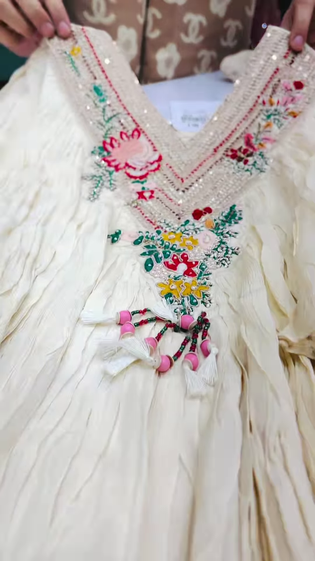 Close-Up of Ivory Crinkle-Fabric Tunic with Vibrant Floral Embroidery